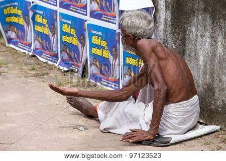 Sri Lankan beggar waits for alms on a street