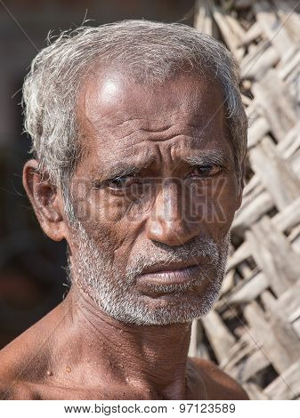Sri Lankan beggar waits for alms on a street