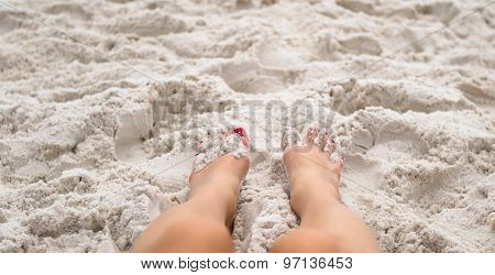 Feet laying on beach