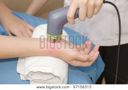 Physical Therapist Using Ultrasound Probe On Woman Patient 's Hand For Release Pain