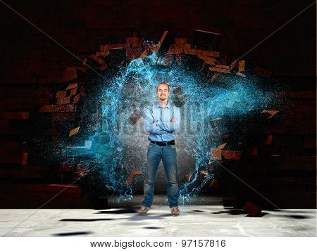 confident man broken brick wall and water spalsh explosion