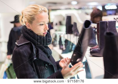Beautiful woman shopping in shoe store.