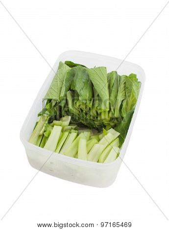 Fresh green vegetable in plastic box isolated on white backhround