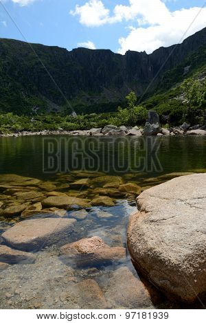 Stones In Lake In Mountains.