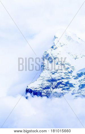 The Swiss Alps at Murren, Switzerland. Jungfrau Region. Tops of the mountains in fog and clouds.