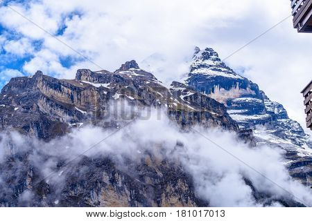 The Swiss Alps at Murren, Switzerland. Jungfrau Region. Tops of the mountains in fog and clouds.