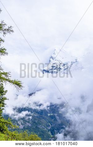 The Swiss Alps at Murren, Switzerland. Jungfrau Region. Tops of the mountains in fog and clouds.