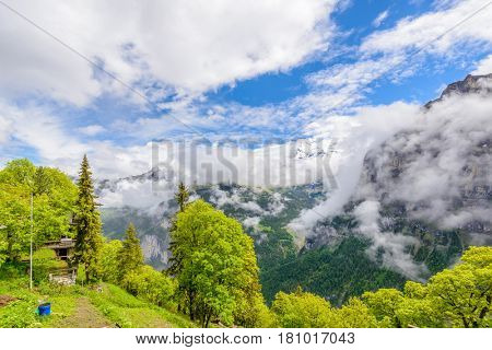 The Swiss Alps at Murren, Switzerland. Jungfrau Region. Tops of the mountains in fog and clouds.
