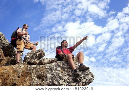 Two men in the beautiful mountains with backpacks and tents.