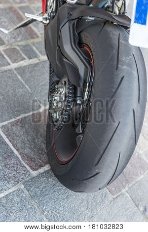 Closeup motorcycle rear wheel and drive chain
