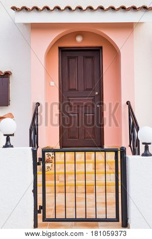 Wooden front door of a home. Front view of a wooden front door.