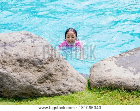 Asian Kid (Girl) in Swimming Pool with Finger Pointing