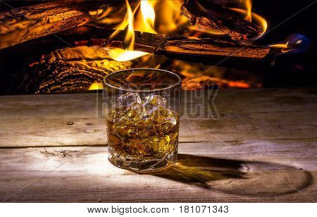 Still life with whiskey on the background of fire