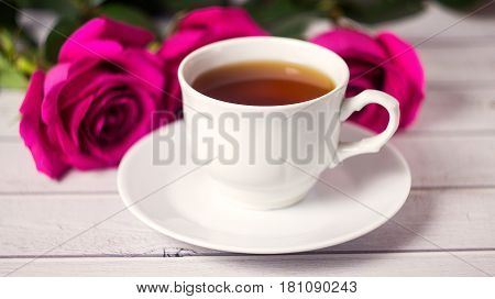 Romantic St Valentine's Or Vedding Setting With Tea Cup And Red Roses