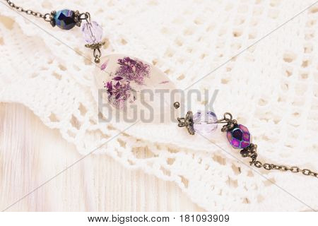 Vintage bracelet on the crochet doily. Creative craft accessory jewelry. Selective soft focus