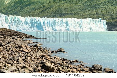 Panoramic lake view of Perito Moreno glaciar in argentinian Patagonia - World famous nature wonder of south american country of Argentina - Natural azure turquoise light blue color tones