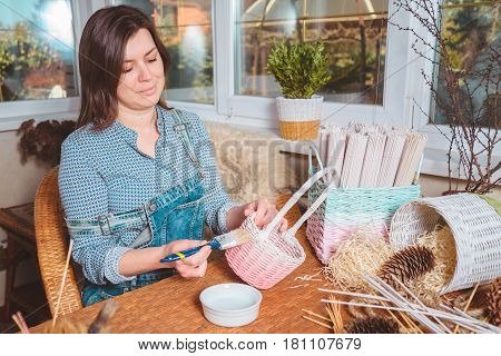 young pretty woman making baskets, home business