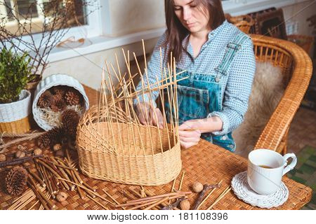 pretty woman making basktes indoor, handmade business