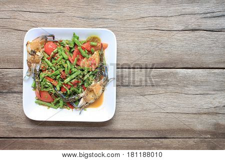 yardlong bean salad with crab of thai foods in white dish on wood background SOMTUM is food of popular in Thailand.