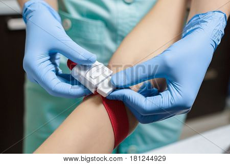 nurse taking blood sample from patient's arm. Preparation of blood to the procedure Plasmolifting.