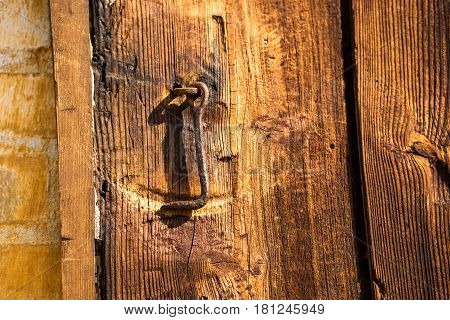 Detail of rusty iron Hook on a vintage wooden door