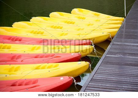 Group of red yellow color Kayak stop at the port