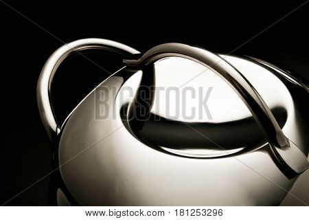 part of steel pot stilllife lighting on the black background