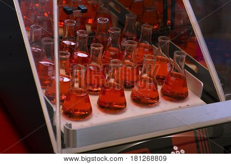 Laboratory test tube shaker. red color in glass