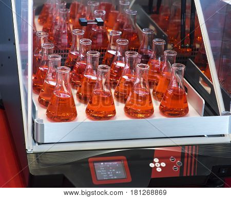 Laboratory test tube shaker. red color in glass
