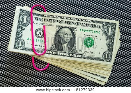 Dollar banknotes with pink clip stapled dollar money