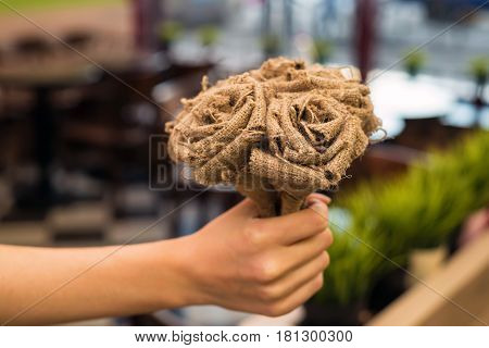 Bouquet of artificial beautiful grey roses made of burlap