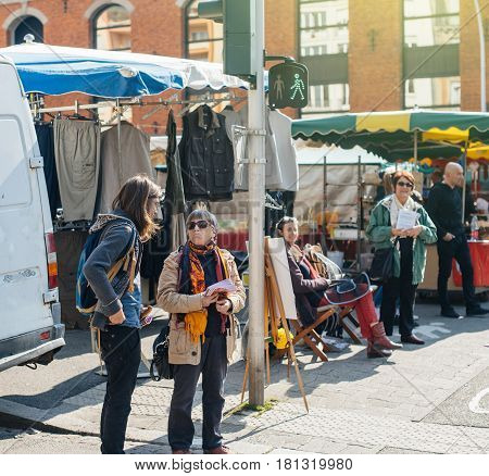 STRASBOURG FRANCE - APR 8 2017: Political agitation at French market for the upcoming French presidential election 2017 - womens distribution leaflets and flyers at market