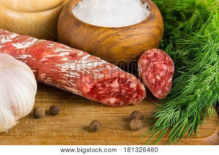 Sliced Salame On Cutting Board, With Dill, Pepper, Salt