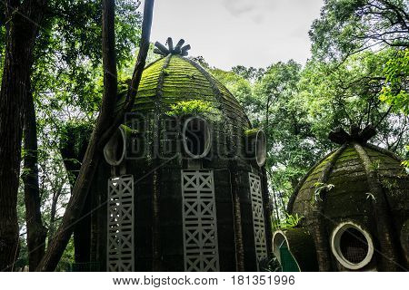 Mossy dome house with round window in the middle of green garden photo taken in Ragunan zoo Jakarta Indonesia java