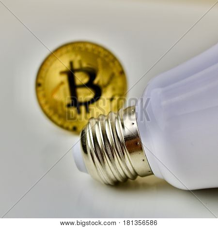 Bitcoin cryptocurrency gold coin and white big bulb