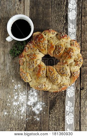 Weaved loaf on dark rustic wooden background. Easter holiday concept.