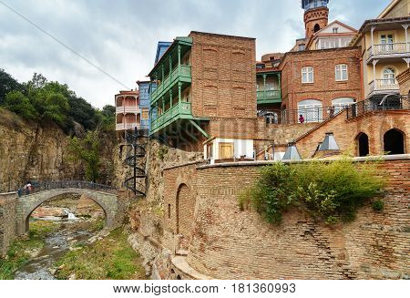 River With Bridge And Houses In Abanotubani District In The Old Town Of Tbilisi. Georgia