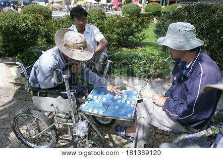Dalat Vietnam - April 7, 2017: Dalat Vietnam - April 7, 2017: Two old man are playing chess in Dalat market.