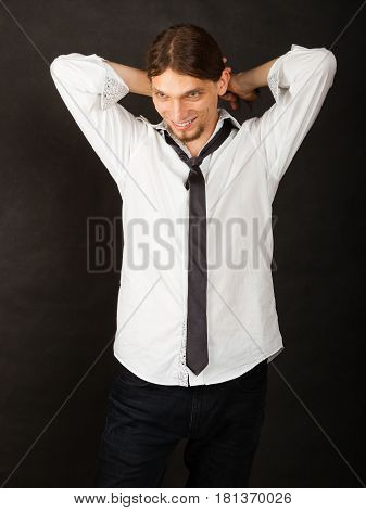 Masculinity fashion concept. Man in shirt and tie. Young long haired male on dark background.