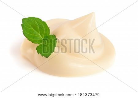 Mayonnaise swirl with a mint leaf isolated on a white background close-up.