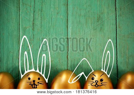 PE047_butterfly_02_bs_nf against golden easter eggs arranged on wooden surface
