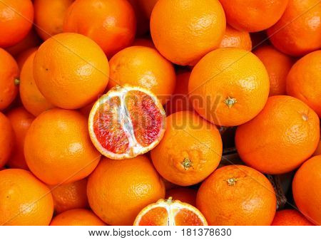 Oranges And An Orange Cut In The Stall Of Greengrocer