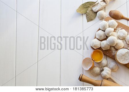 Flat lay. Cooking delicious dumplings on the white wooden table