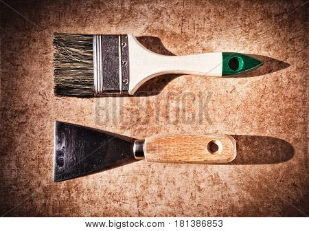 A Brush And A Paint Spatula.