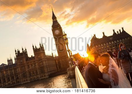London, UK - April 2, 2015: Random people on Westminster Bridge in sunset on 2th of April, 2017 in London. Big ben and Palace of Westminster aka Houses of Parliament in background.
