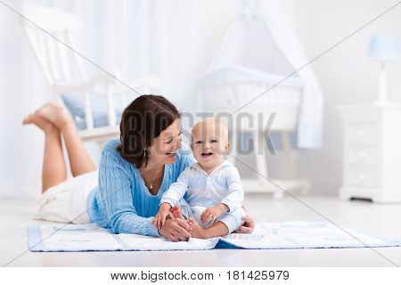 Mother And Baby Playing On The Floor