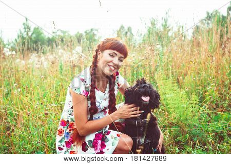 Beautiful woman playing with her dog. Outdoor portrait. series