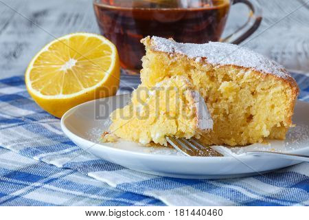 Emon Cake With Sugar Powder On The Wooden Table