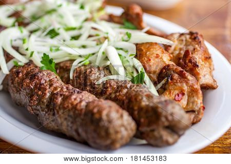 Traditional Georgian Mtsvadi Pork Barbecue And Kebab With Onion And Parsley
