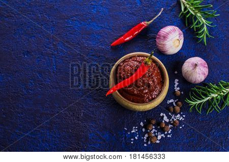 Red tomato sauce with spices. Selective focus.